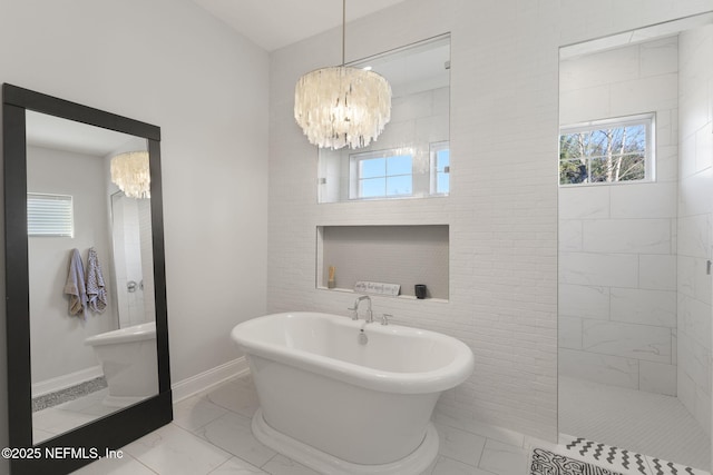 bathroom featuring plus walk in shower and a chandelier