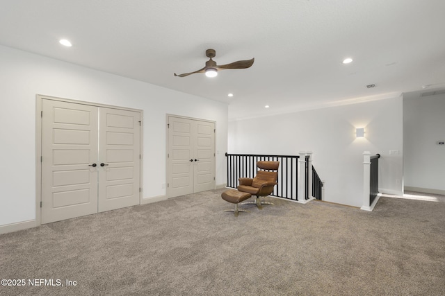 unfurnished room with ceiling fan and carpet