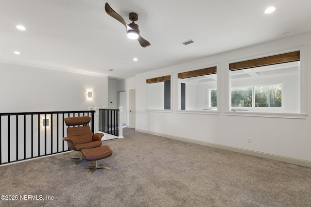 living area featuring ceiling fan and carpet flooring