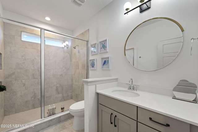 bathroom with vanity, toilet, and an enclosed shower