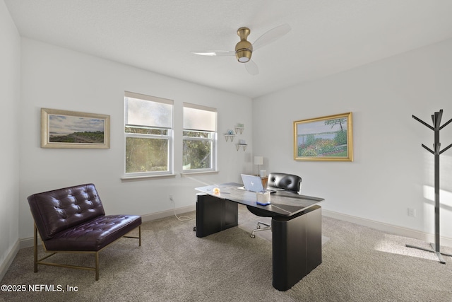 carpeted office space featuring ceiling fan