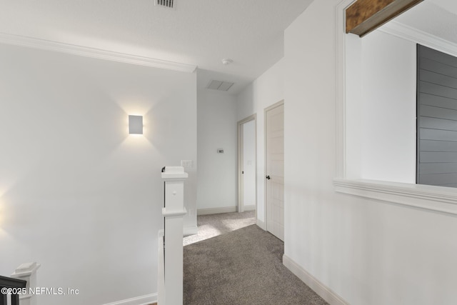 corridor with dark colored carpet and ornamental molding