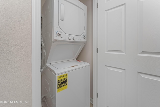 laundry area with stacked washer and clothes dryer