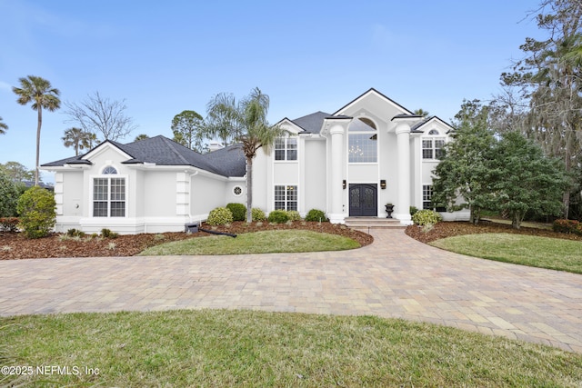 view of front of home with a front lawn and stucco siding