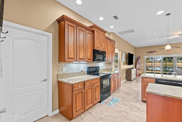 kitchen with tasteful backsplash, hanging light fixtures, black appliances, and light stone countertops