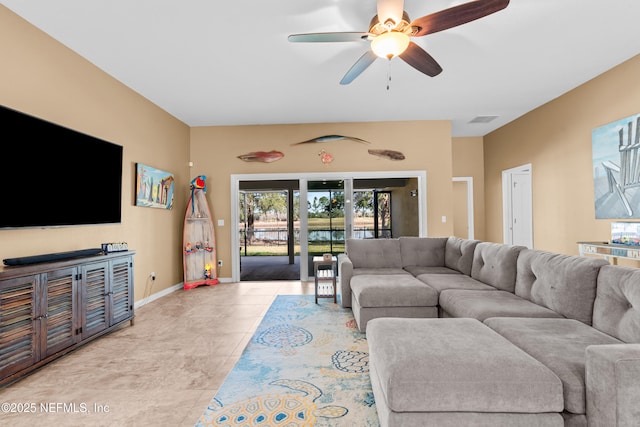 tiled living room featuring ceiling fan