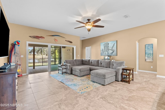 tiled living room featuring ceiling fan