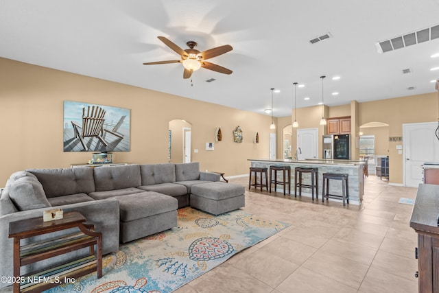 living room with light tile patterned floors and ceiling fan