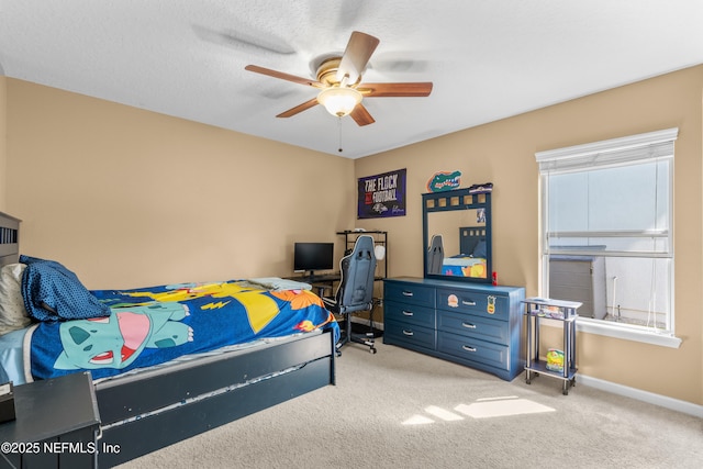 carpeted bedroom with a textured ceiling and ceiling fan