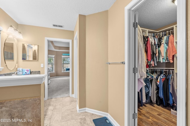 bathroom with vanity and a textured ceiling