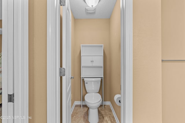 bathroom featuring toilet and tile patterned flooring