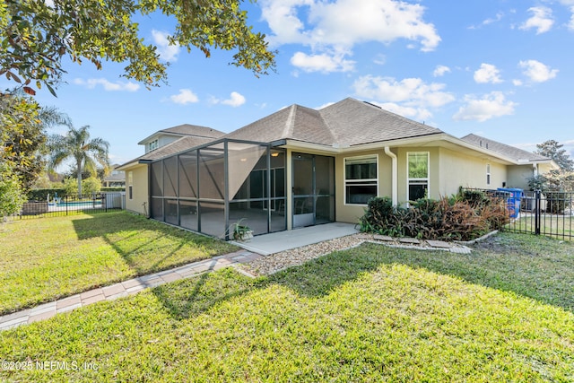 rear view of property featuring a yard, a lanai, and a patio area