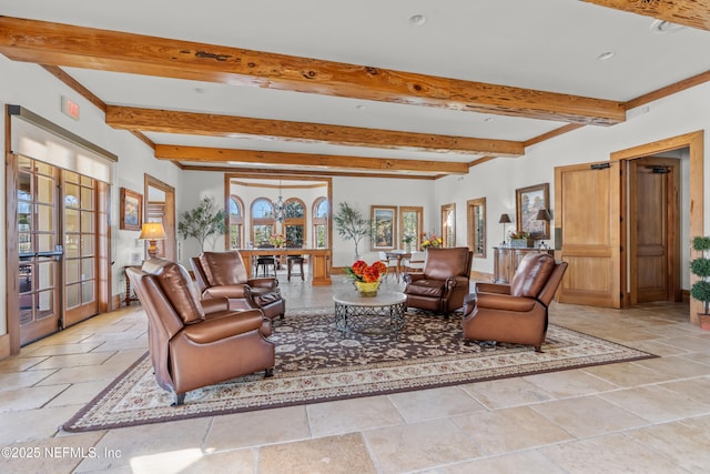 living room featuring beamed ceiling and french doors