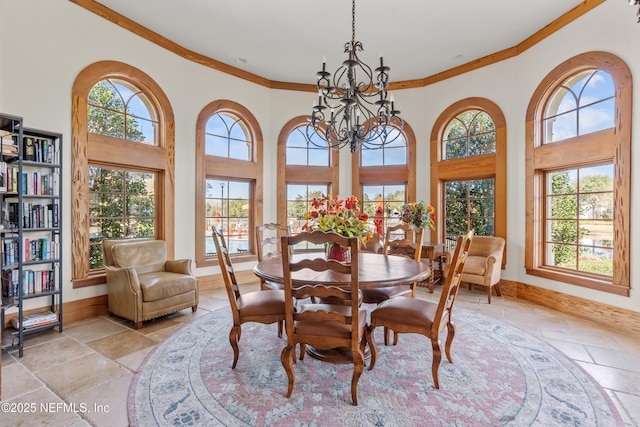 dining room with a wealth of natural light, a chandelier, and a high ceiling