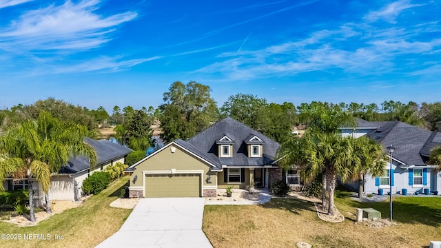 view of front of house featuring a garage and a front lawn