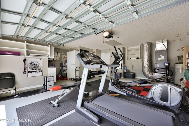 exercise room with electric water heater and a textured ceiling