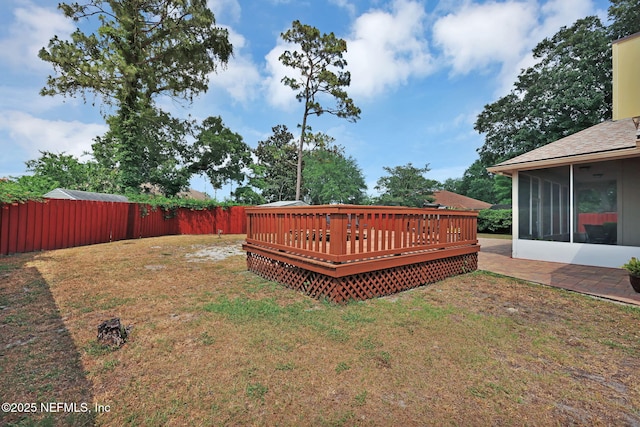 view of yard with a wooden deck and a sunroom