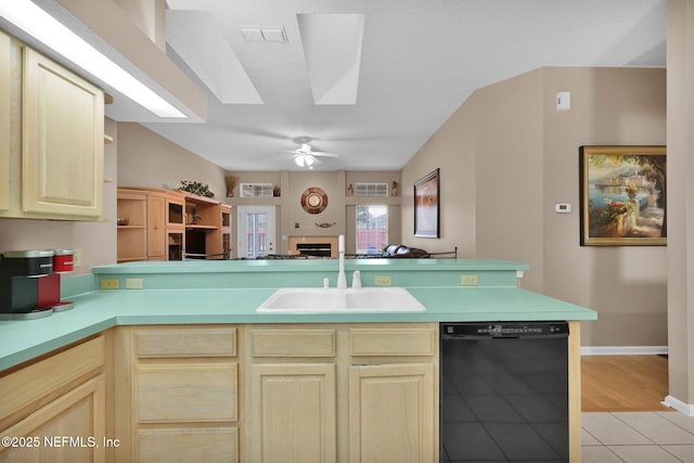 kitchen with dishwasher, sink, light tile patterned floors, ceiling fan, and light brown cabinets