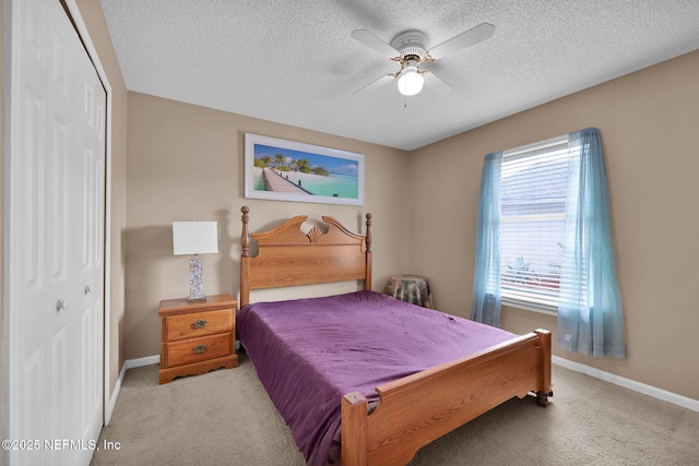 carpeted bedroom with multiple windows, ceiling fan, and a closet