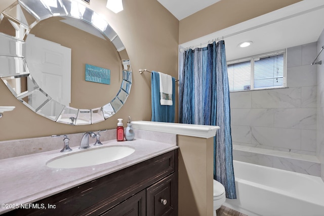 full bathroom with vanity, shower / tub combo, and toilet