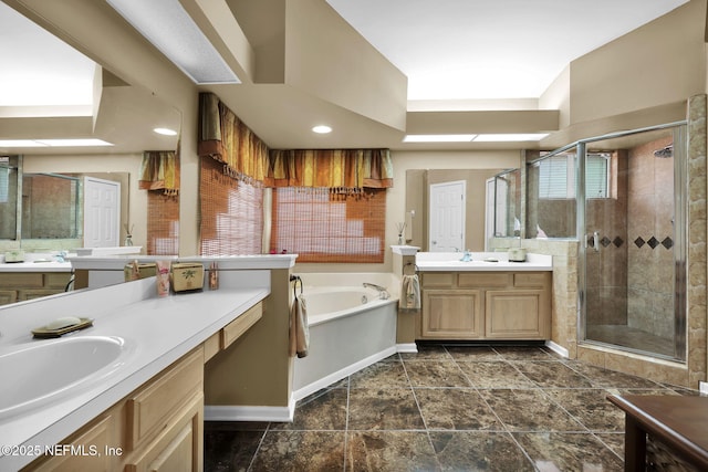 bathroom with vanity and separate shower and tub