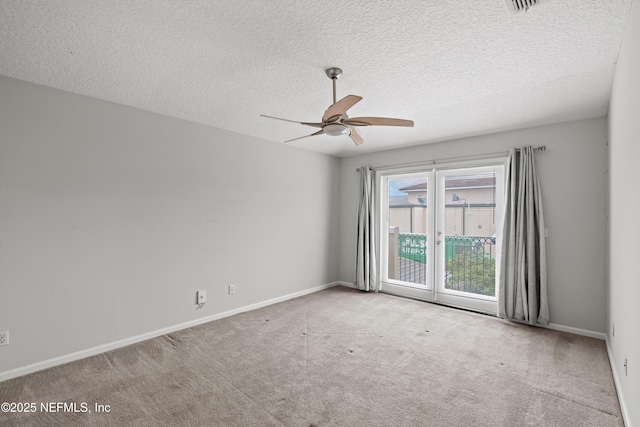 carpeted empty room featuring ceiling fan and a textured ceiling