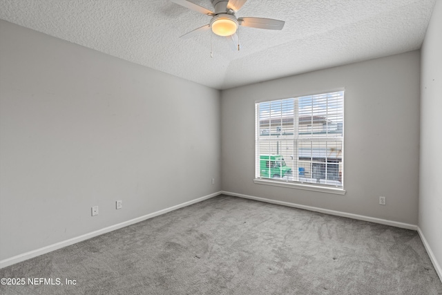 spare room with ceiling fan, carpet floors, and a textured ceiling