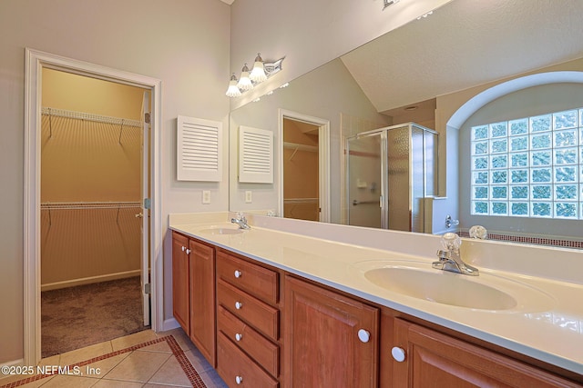 bathroom with vanity, an enclosed shower, tile patterned flooring, and vaulted ceiling