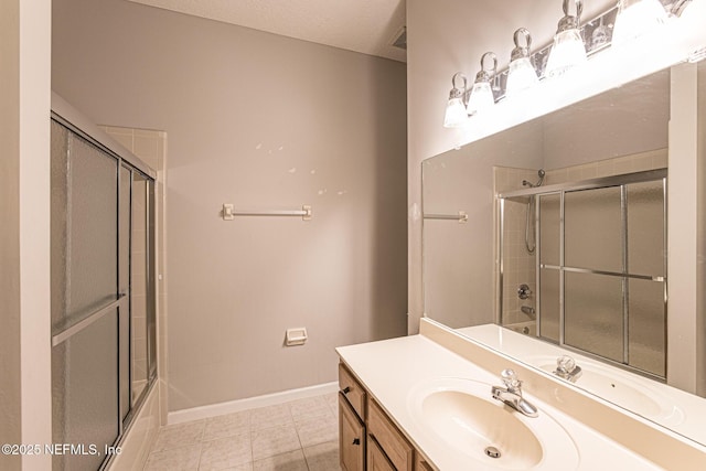 bathroom with enclosed tub / shower combo, vanity, tile patterned flooring, and a textured ceiling