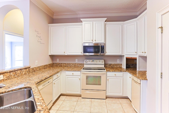 kitchen featuring sink, white appliances, white cabinets, and stone counters