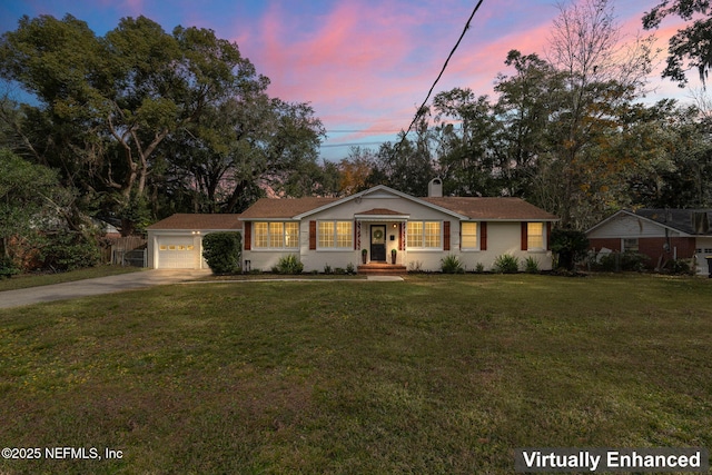 single story home featuring a yard and a garage