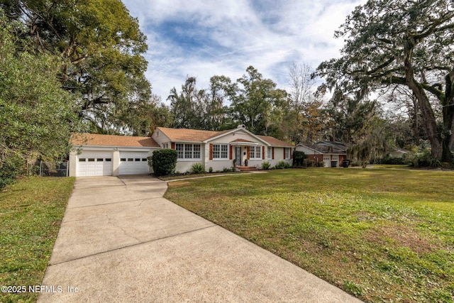 ranch-style house with a garage and a front lawn