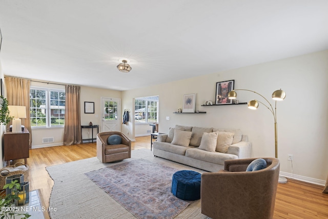 living room with a wealth of natural light and light wood-type flooring