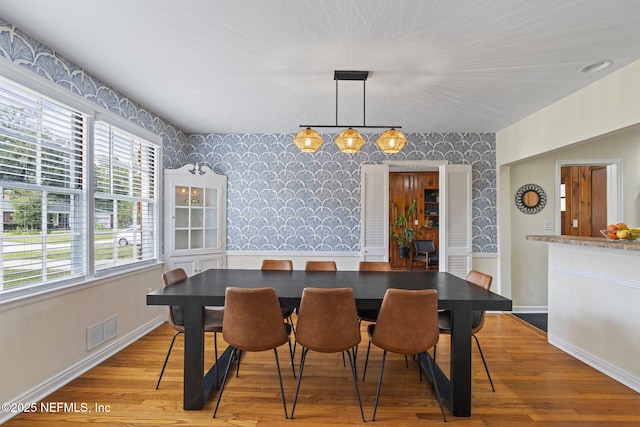 dining area with hardwood / wood-style floors