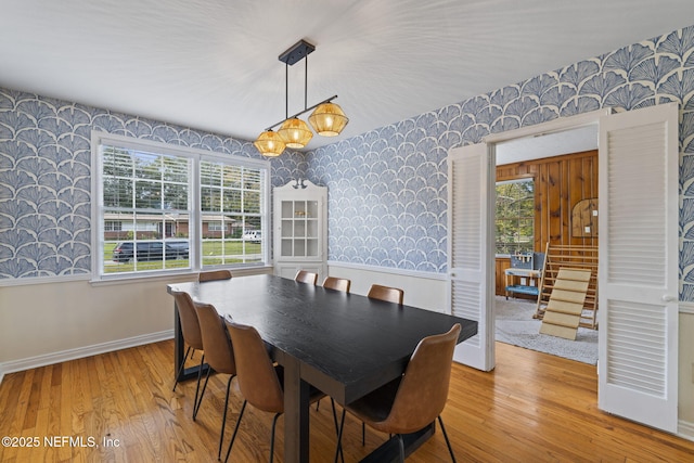 dining room featuring a healthy amount of sunlight and light hardwood / wood-style flooring