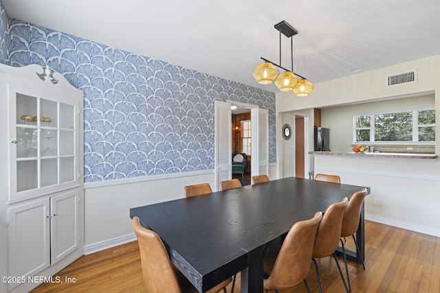 dining space featuring light wood-type flooring