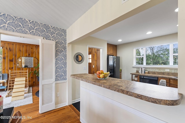 kitchen featuring wood-type flooring and black appliances