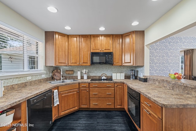 kitchen featuring backsplash, a wealth of natural light, sink, and black appliances