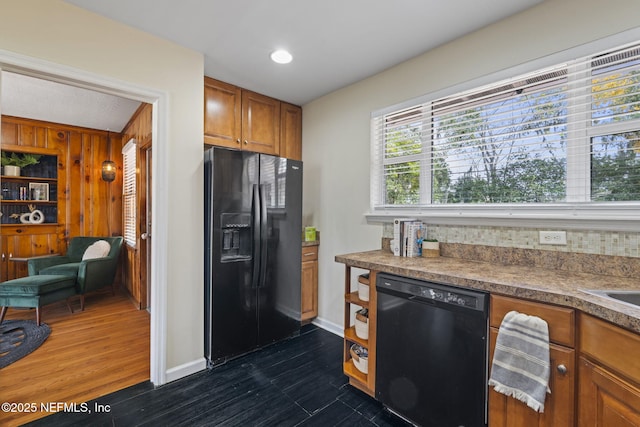 kitchen featuring dark hardwood / wood-style flooring and black appliances