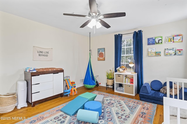 rec room with wood-type flooring and ceiling fan