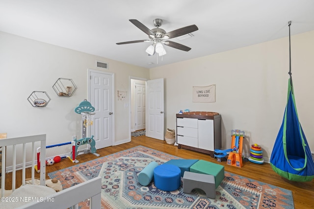 bedroom with hardwood / wood-style floors and ceiling fan