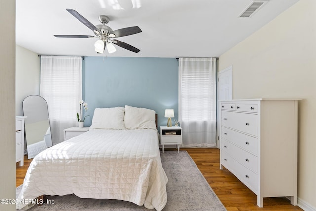 bedroom with hardwood / wood-style flooring and ceiling fan