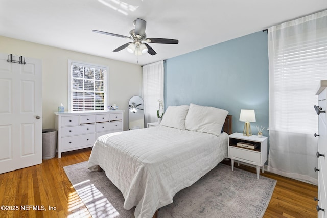 bedroom with wood-type flooring and ceiling fan