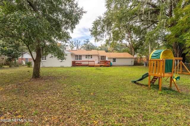 view of yard featuring a playground and a wooden deck