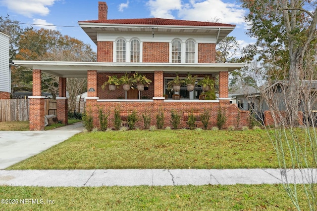 view of front of home with a front yard and a porch