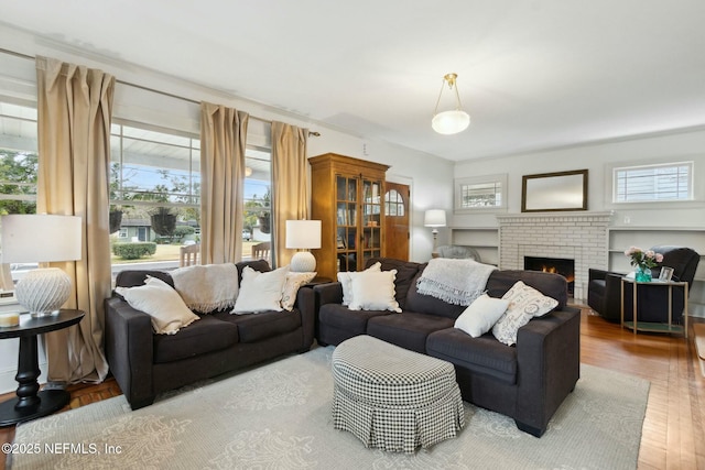 living room featuring hardwood / wood-style flooring and a fireplace