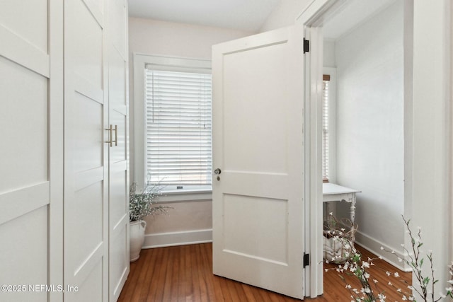 hallway with hardwood / wood-style flooring