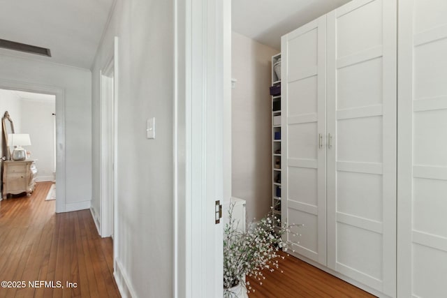 hallway with hardwood / wood-style floors