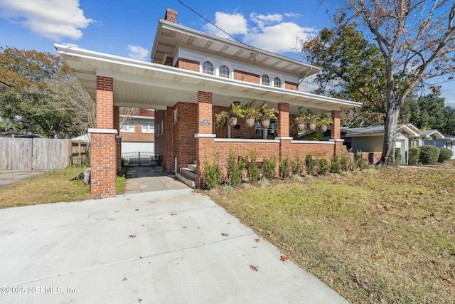 view of front of house featuring a front yard and covered porch