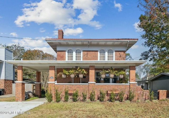 view of front of property featuring covered porch and a front yard